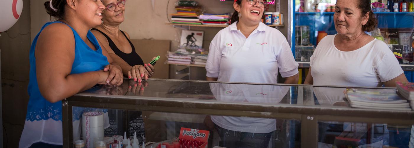 Photo description: Women business owners at a store counter in Colombia. Credit: USAID/Colombia Rural Finance Initiative