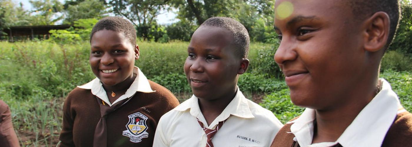 Photo: Shown standing in a demo garden at St. Paul’s College, Nelima, Bridget, and Philomena are proud members of the Youth Farmers Club at their secondary school in Mbale, Uganda.