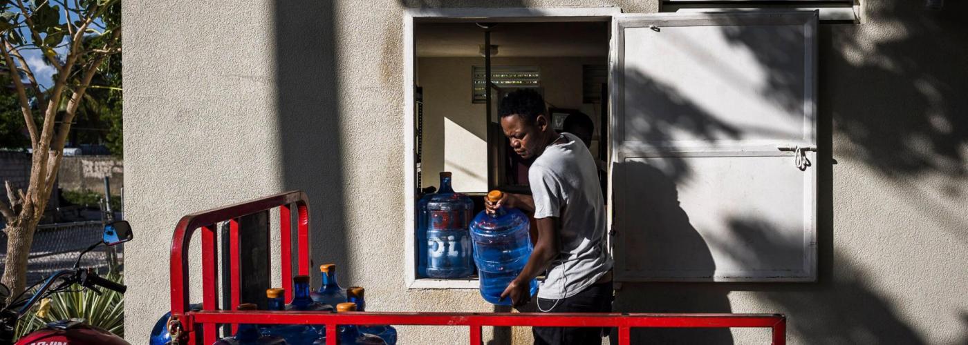 Photo: A delivery agent picks up water from a kiosk. 