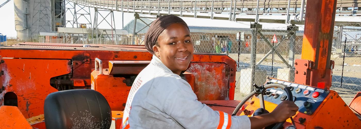 Johannesburg, South Africa - August 11 2008: Underground Platinum Palladium Female Miner operating vehicle machinery used to move ore rocks