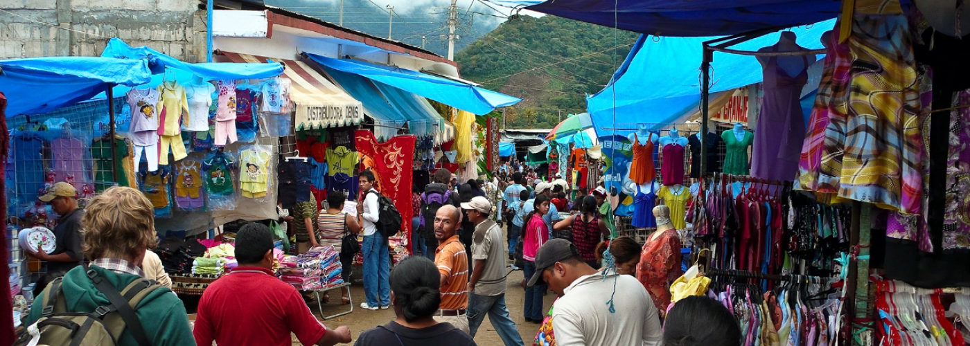 Busy outdoor market selling clothes 