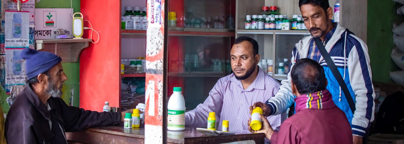 Customers at an agri-inputs shop in Bangladesh