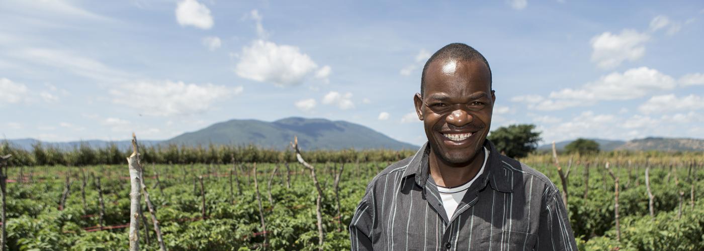 Photo: Male farmer standing in field in Tanzania. 