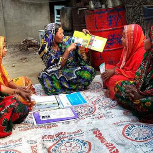 Group of women learning about safe practices in an agro-retail shop in Bangladesh. Photo by Ashraful Islam.