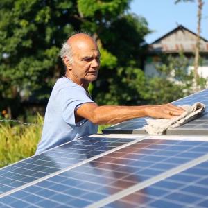 Photo: Man cleans solar panels