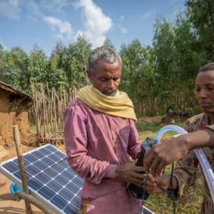 Sewagegn, a local smallholder farmer, and Gebeyaw, a data collector, set up Sewagegn's solar powered pump to irrigate her backyard garden in Danghesta, Amhara region of Ethiopia