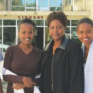 Four Ethiopian women stand in front of a library. 