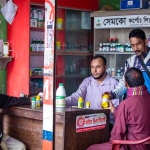 Customers at an agri-inputs shop in Bangladesh