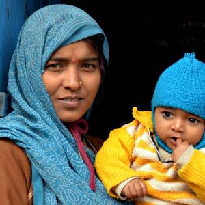 Woman in India holding a baby.