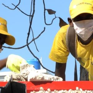 men recycling crushed rubble in Haiti