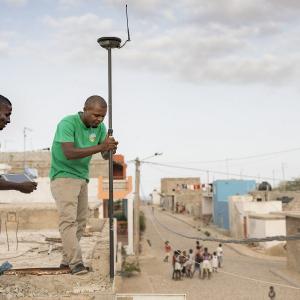 Photo: Technicians Ismael Rodrigues (left) and Jose Silva (right) work to survey and geomap a property on the island of Maio as part of the MCC-Cabo Verde Compact. Accurate information about land rights and ownership is important to facilitating private investment in Cabo Verde, where tourism is a major driver of the economy.